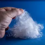 80mm superabsorbent long staple fibre 102/80/10 close up shown on blue background